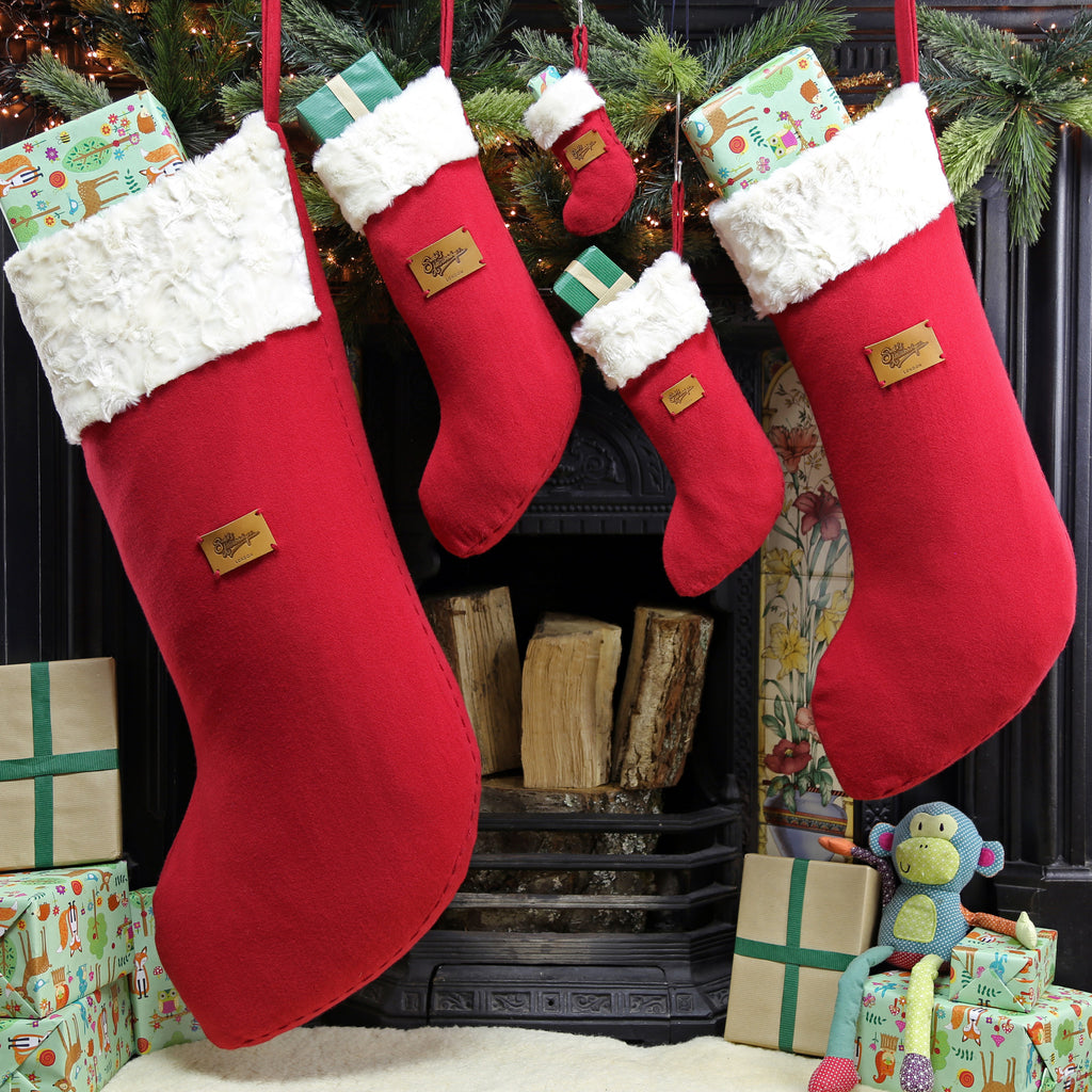 Set of five Christmas stockings hanging on the mantlepiece