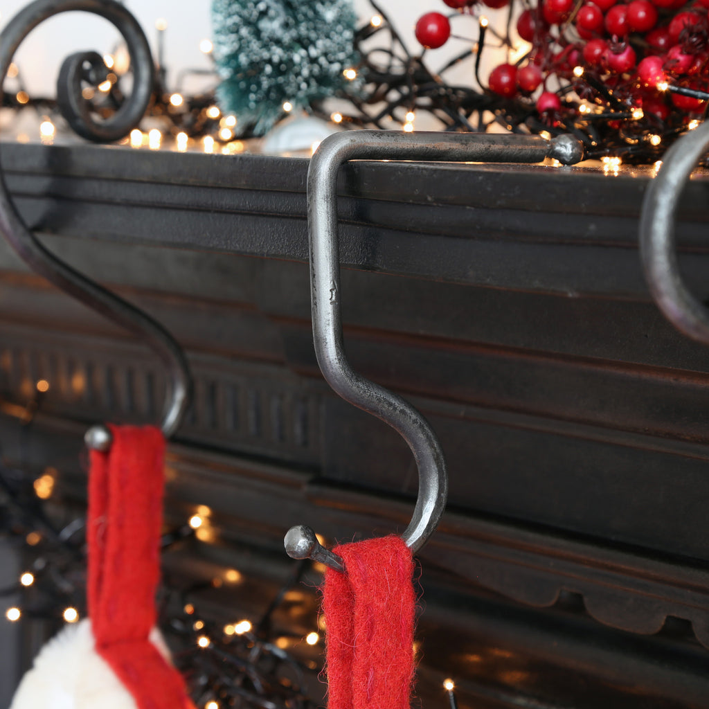 Handmade Forged Iron Christmas Stocking hook suitable for hanging on a fireplace or mantlepiece