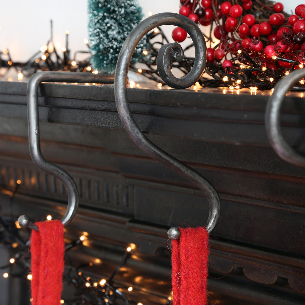 Artisanal spiral hook designed to hang Christmas stocking on fireplaces.
