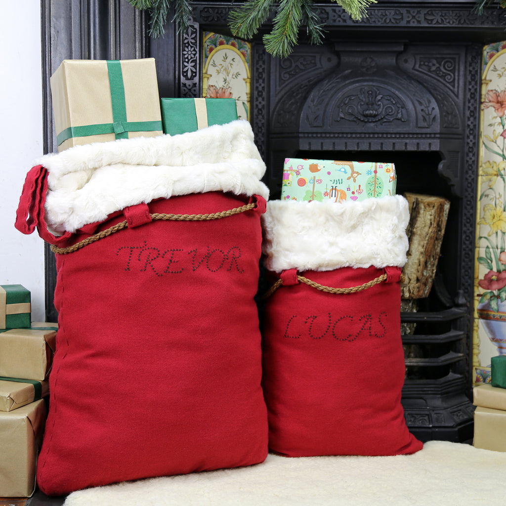Deluxe merino wool personalised Santa sacks filled with presents ready for the Christmas Eve
