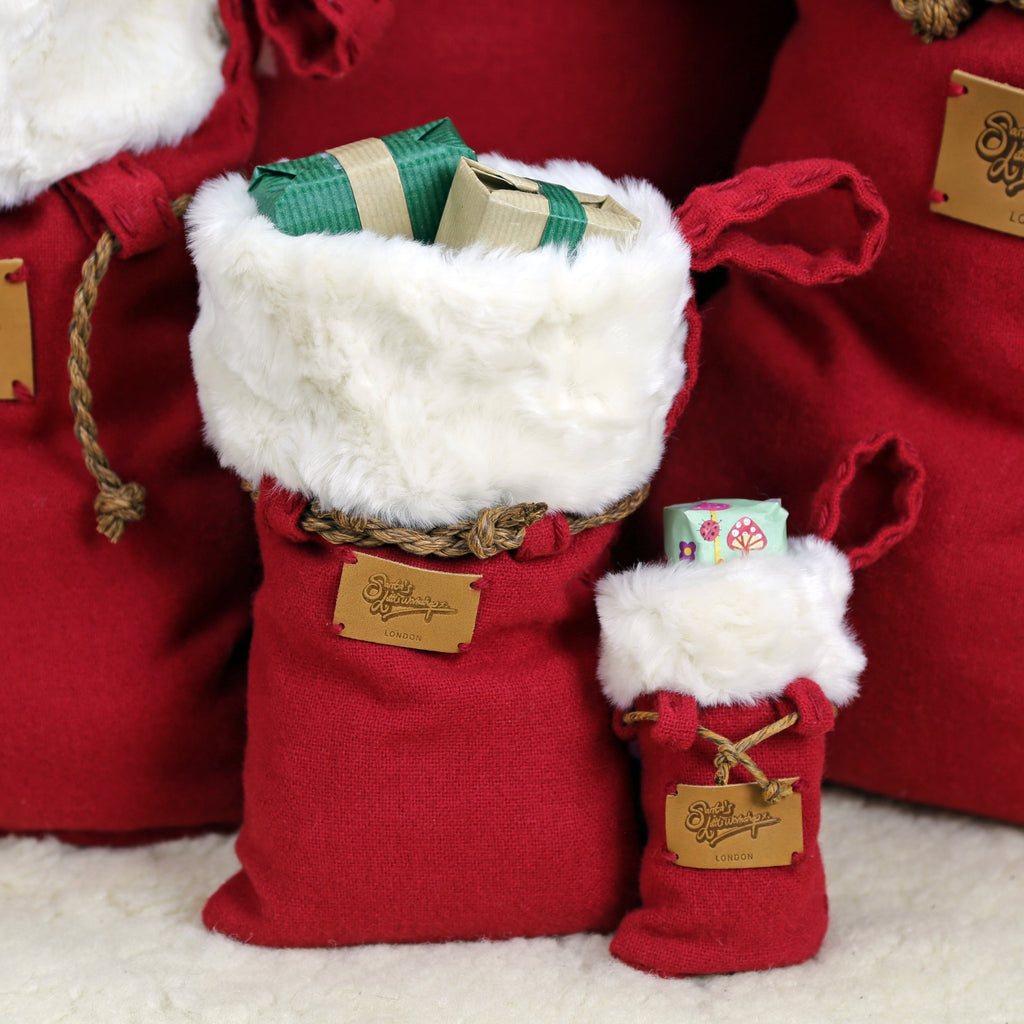 Small and elegant Santa sack hand-crafted from the softest merino wool with plush faux fur trim
